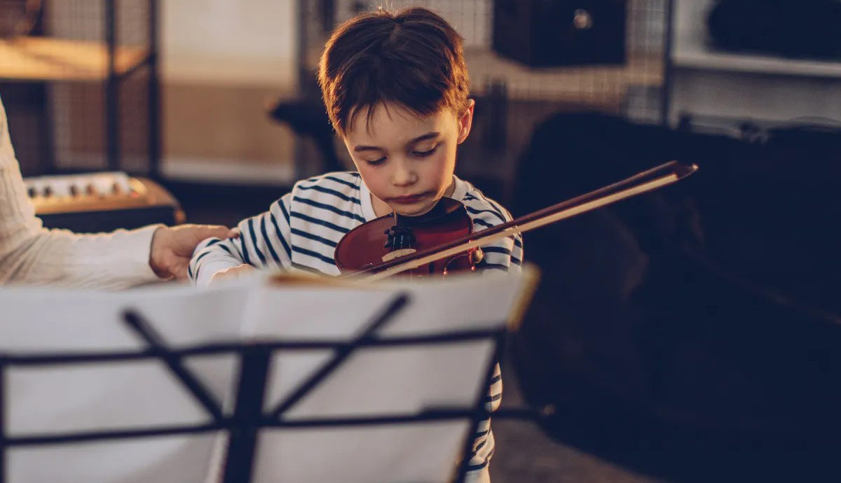 Closeup of boy playing violin