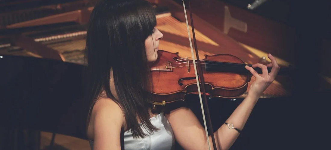 Woman playing a violin in a concert hall
