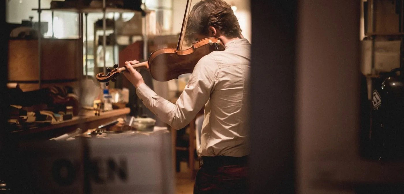 Man standing and playing the violin